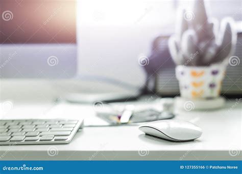Computer Desktop With White Keyboard And Mouse On Working Desk Stock