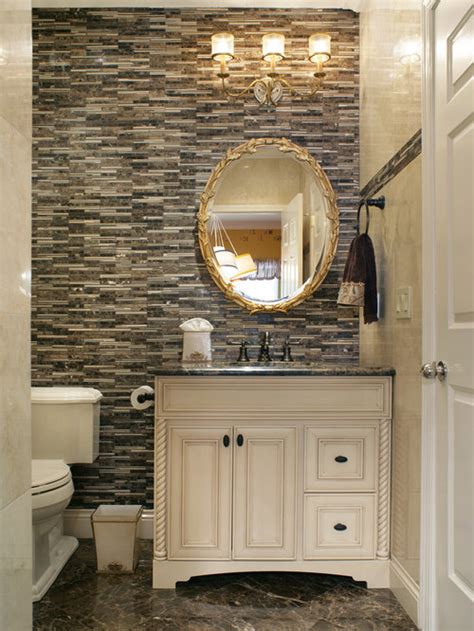 Elegant contemporary powder room features a honed white marble and polished brass washstand completed with a round sink paired with a polished brass faucet positioned in front of a grid mirror mounted to a wall covered in gorgeous gray hand painted wallpaper. Elegant Powder Room | Houzz