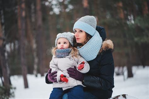 Happy Mother And Daughter On The Walk In Snowy Winter Stock Image
