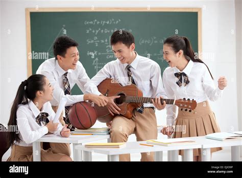 High School Students To Play The Guitar In The Classroom Stock Photo