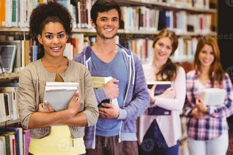 Happy Students Holding Books In Row 1063635 Stock Photo At Vecteezy