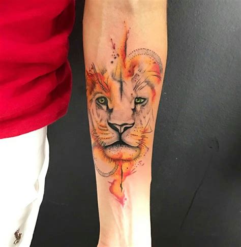 A Womans Arm With A Tattoo On It That Has A Lion Face And Leaves