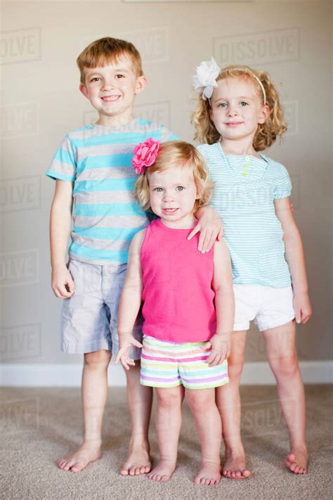 Familly Portrait Of Three Siblings Stock Photo Dissolve