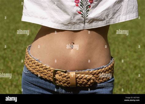Woman Shows Her Bare Midriff With A Belly Button Ring While Wearing A Stock Photo Royalty Free