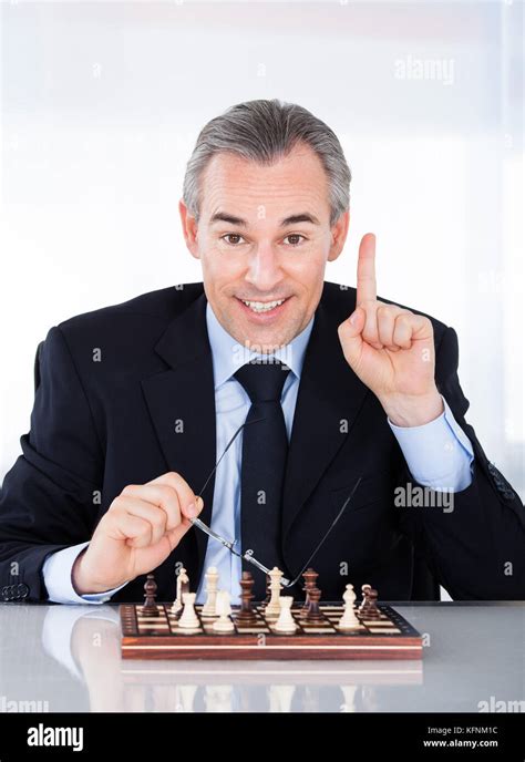 Mature Businessman Playing Chess And Gesturing Indoors Stock Photo Alamy