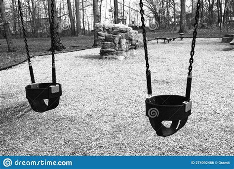 Two Empty Swings At The Playground In The Park Stock Photo Image Of