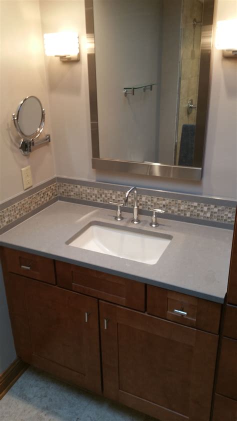 This pretty upgrade adds a pop of color. Backsplash-mosaic glass tile with Caesarstone wrap to ...