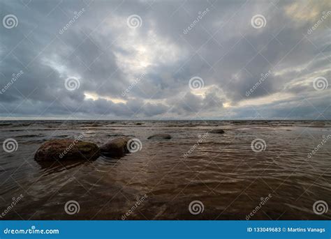 Storm Clouds Forming Over Clear Sea Beach With Rocks And Clear S Stock