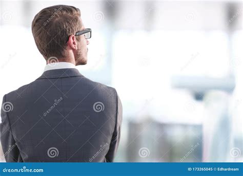 Rear Viewbusinessman Standing Near The Office Window Stock Image