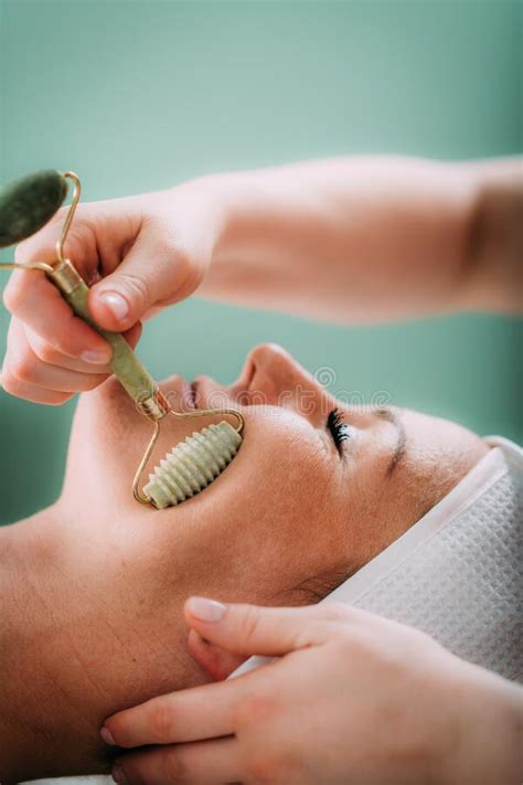 Guasha Face Massage In Beauty Salon Massage Technique For Stimulating Pressure Points On The