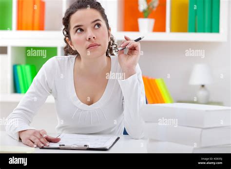 Thinking Teenager Girl Sitting At Desk And Learning Stock Photo Alamy