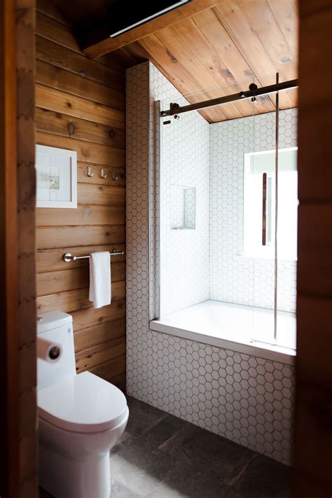 these rustic shower ideas are giving us major cozy cabin vibes hunker small cabin bathroom