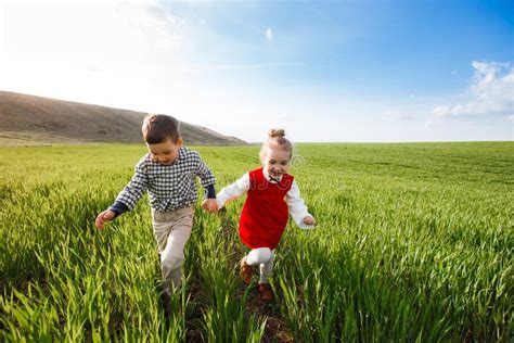 Little Children Running Through The Meadow Stock Image Image Of