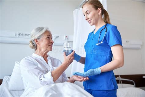Nurse Giving Medicine To Senior Woman At Hospital Stock Image Image Of Cardiologist Elderly