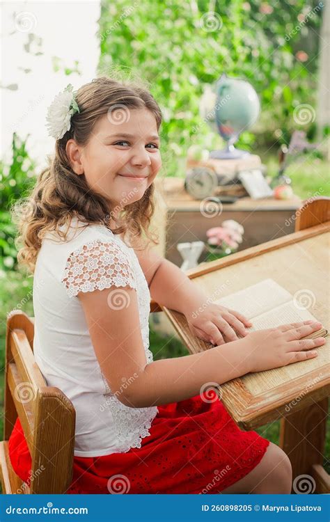 Girl Schoolgirl Sits Behind Wooden Desk Outdoor Near School Learning