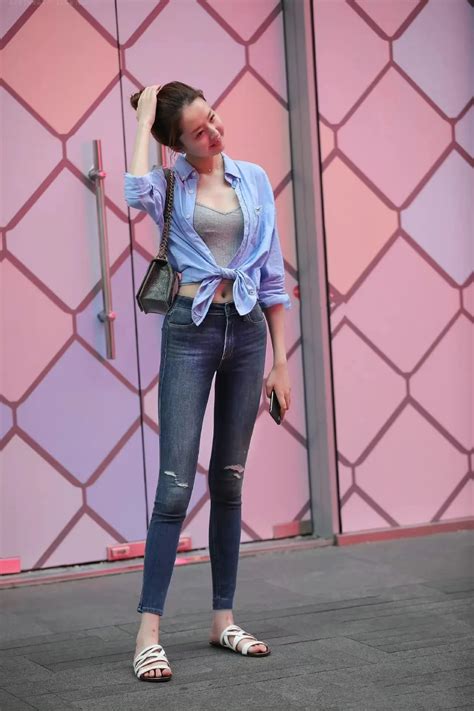 Beautiful Girl Showing Off Her Long Legs In A Cropped Shirt With Slim Jeans And Slippers Imedia