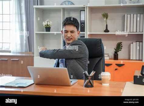 Young male employee in oversleeping and lazy in office person sitting