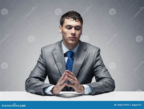 Young Man Folded Hands And Having Serious Face Stock Photo Image Of