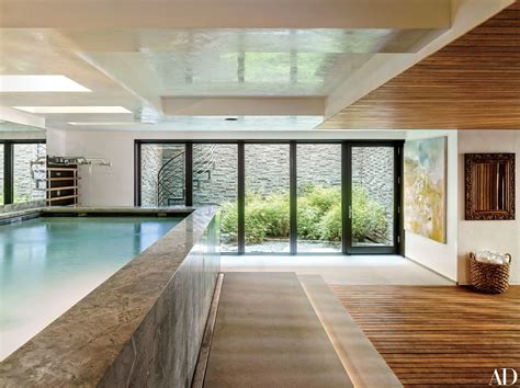 An Indoor Swimming Pool In The Middle Of A Room With Sliding Glass