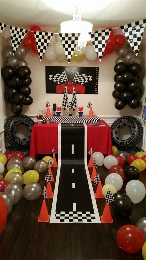 A Birthday Party With Balloons And Race Car Decorations On The Wall