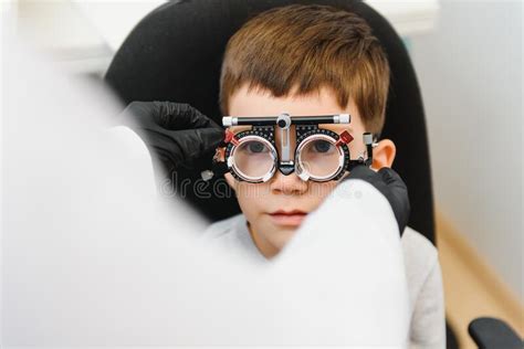 Cheerful Child Boy In Glasses Checks Eye Vision Pediatric