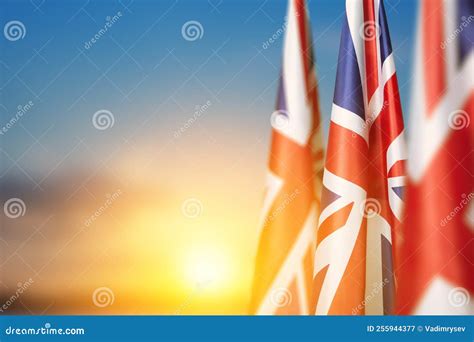 National Flags Of United Kingdom On A Flagpole On Sunset Sky Background