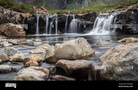 Fairy Pools Waterfalls Surrounded By Mountains During A Cloudy Day On