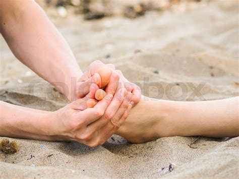 foot massage on a beach in sand male and female caucasian stock image colourbox