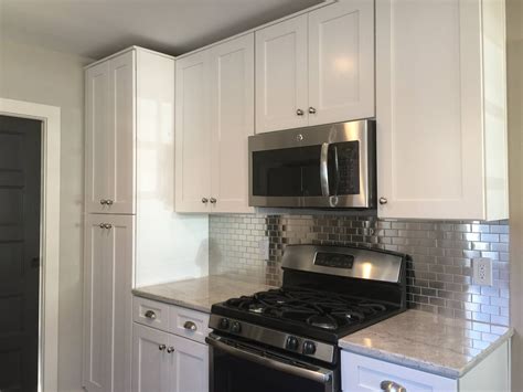 This includes giving the backsplash a 1/2 lip to accommodate the shelf, and it also includes mounting holes and spacers. White Cabinets with stainless steel backsplash by Frame to ...