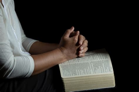 Free Photo Hands Folded In Prayer On A Holy Bible In Church