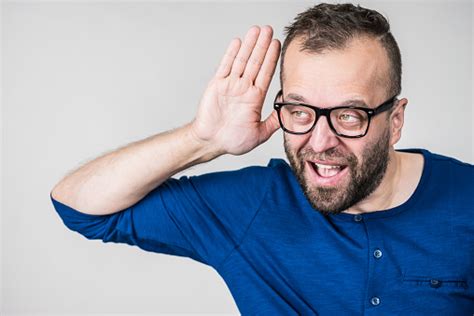 Man Eavesdropping With Hand Close To Ear Stock Photo Download Image