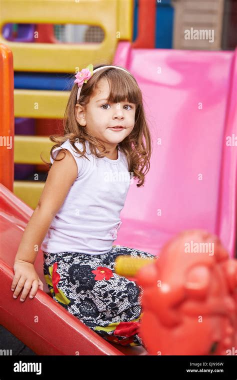 Happy Child Playing Inside On A Slide Stock Photo Alamy