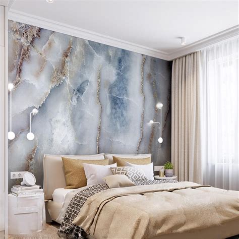 A Bedroom With Marble Wallpaper And White Bedding