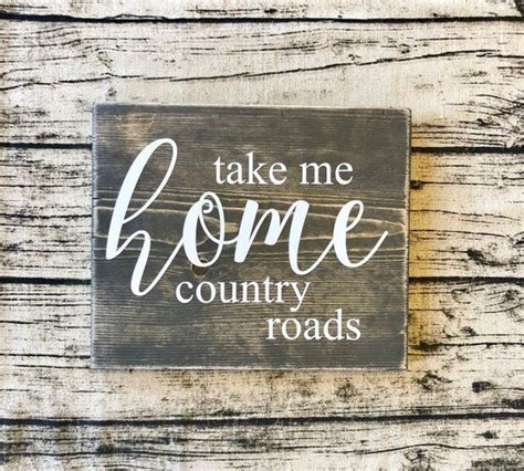 A Wooden Sign That Says Take Me Home Country Roads