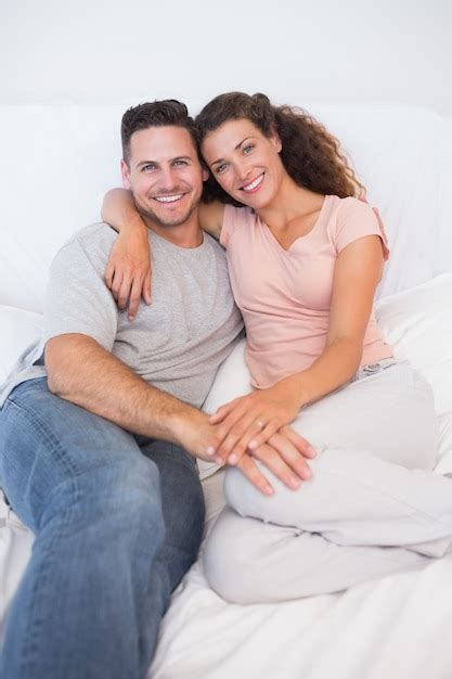 Premium Photo Happy Couple Sitting On Bed