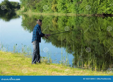 Retired Active Man Is Fishing At The River Bank Stock Image Image Of