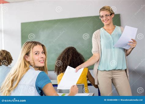 Teacher Handing Paper To Student In Class Stock Photo Image Of