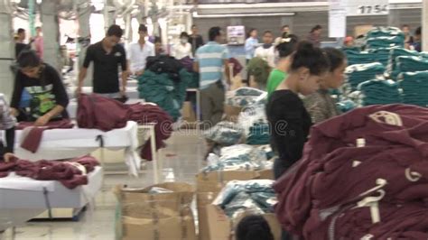 Textile Garment Factory Workers Worker Unwraps Bundle At Machine