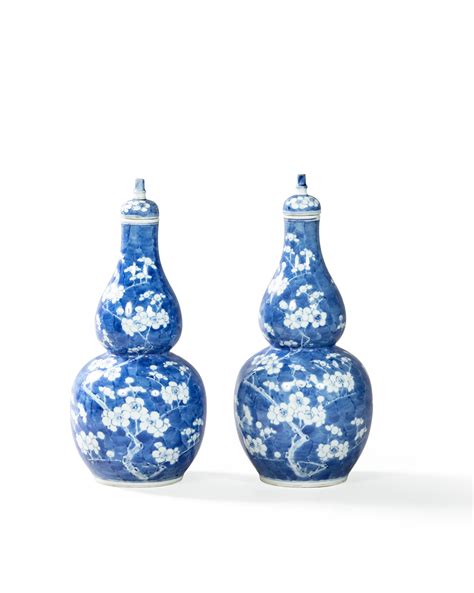 A Pair Of Blue And White Double Gourd Prunus Vases And Covers China