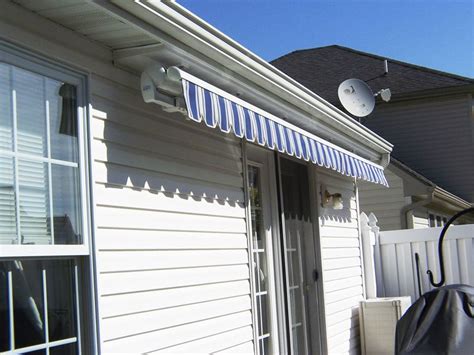 Retractable Blue Estate Awning In An Under Soffit Mount House