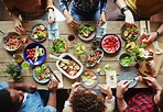 Group of young people eating dinner - Stock Photo - Dissolve