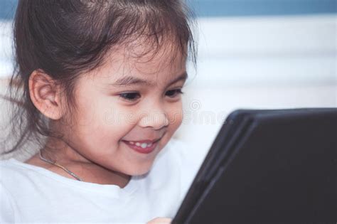 Happy Asian Child Sitting On The Garden Chair Stock Photo Image Of