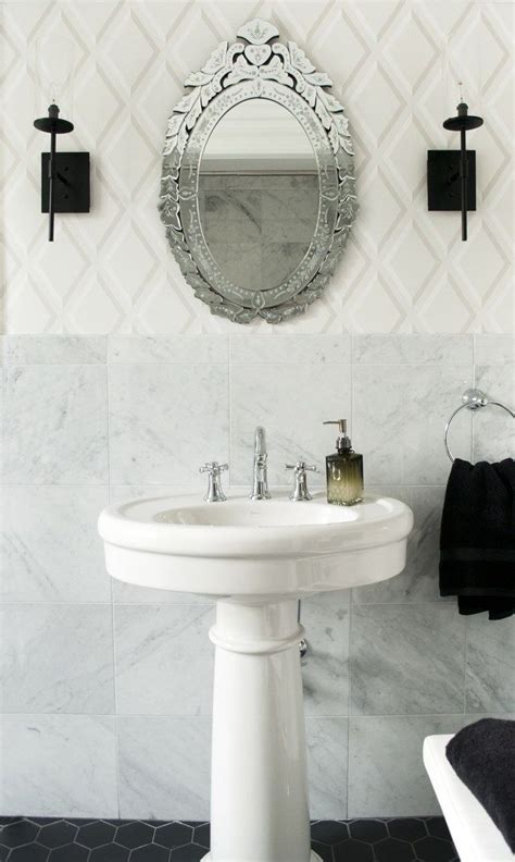 Venetian Mirror Above Pedestal Sink With Marble And Black Tile