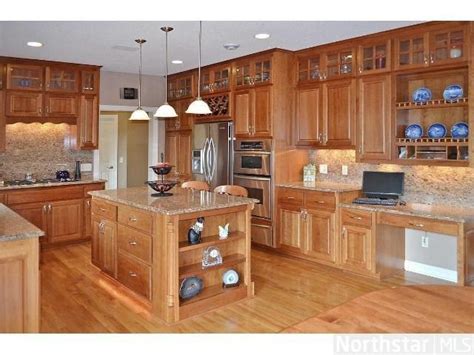 We realize that no two kitchens are alike in their design and each persons needs it is not easy to design a kitchen. Masterfully designed kitchen features red birch flooring ...