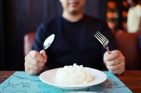 Premium Photo Man Eating Rice Enjoying A Meal In Restaurant
