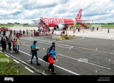 Passengers Disembarking From An Air Asia Flight At Sandakan Airport