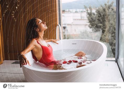 Woman Lying In Bathtub Filled With Charcoal Water A Royalty Free Stock Photo From Photocase