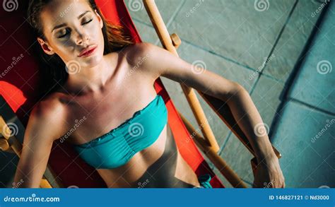 Woman Relaxing And Sun Tanning By The Swimming Pool Stock Image Image