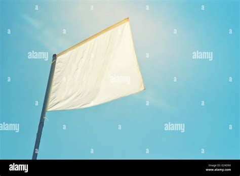 Blank White Flag Banner Waving Against The Sun Light Copy Space For