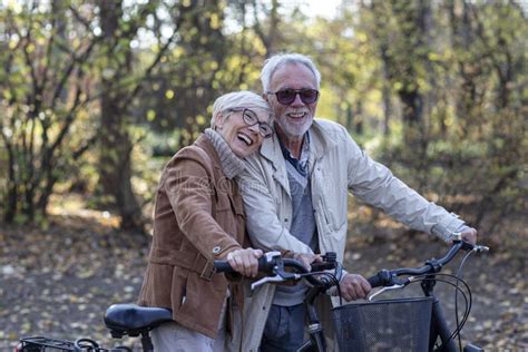 Old Mature Couple With Bikes In Park Stock Image Image Of Mature Casual 180408159